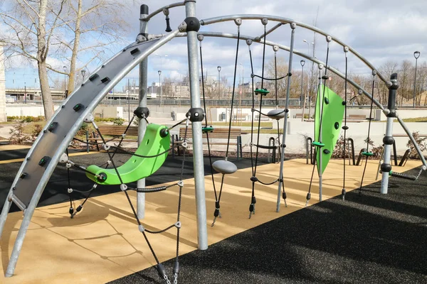 A modern playground in the city park for games and sports. Public place for families with children.