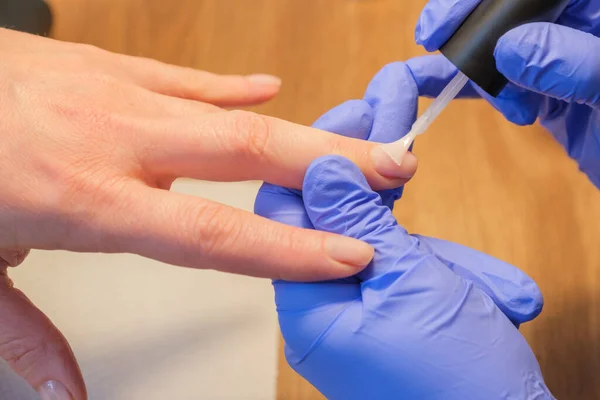 Μανικιουρίστα Εφαρμόζει Βερνίκι Στα Νύχια Του Πελάτη Και Χρησιμοποιεί Προστατευτικά — Φωτογραφία Αρχείου