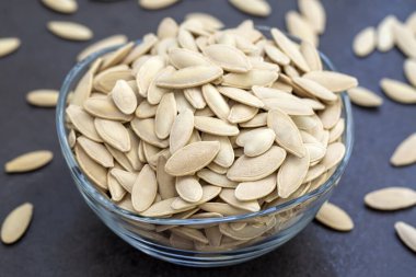 close up view pumpkin seeds in a bowl