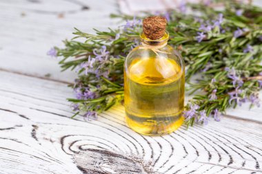 lavender essential oil with flowers on wooden background