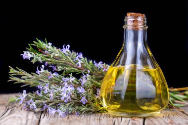lavender essential oil with flowers on wooden background