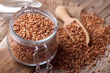 buckwheat in a glass jar on a wooden background