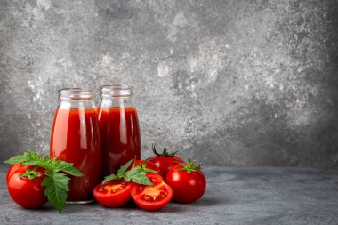 Tomato juice in a glass and fresh tomatoes