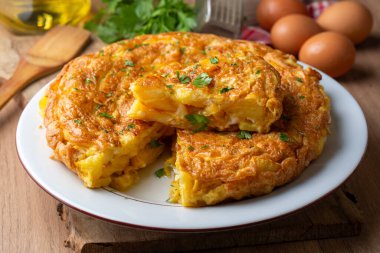 Spanish omelette with potatoes, typical spanish cuisine on gray concrete floor. Tortilla Espanola. Turkish name; Yumurtali patates