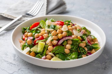 Domates, roka, maydanoz, ıspanak ve kırmızı soğanlı vejetaryen nohut salatası. Sağlıklı yiyecekler, diyet. Üst görünüm