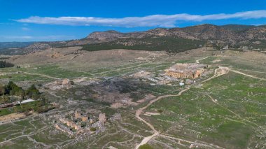 Türkiye 'nin Pamukkale kentindeki pitoresk bir vadide antik harabelerin ve manzaralı dağların havadan görünüşü.