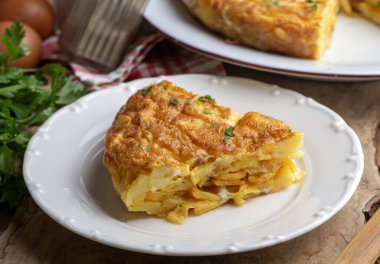 Spanish omelette with potatoes, typical spanish cuisine on gray concrete floor. Tortilla Espanola. Turkish name; Yumurtali patates