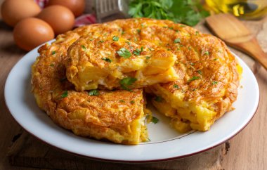 Spanish omelette with potatoes, typical spanish cuisine on gray concrete floor. Tortilla Espanola. Turkish name; Yumurtali patates