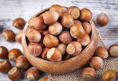 Shelled Hazelnuts is important for health on the wooden background