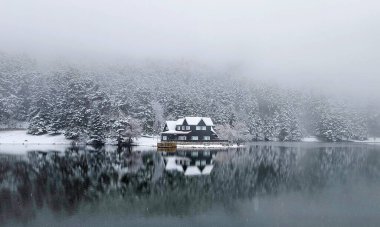 Bolu Golcuk Milli Parkı, Türkiye 'de karlı bir kış gününde göl ahşap evi
