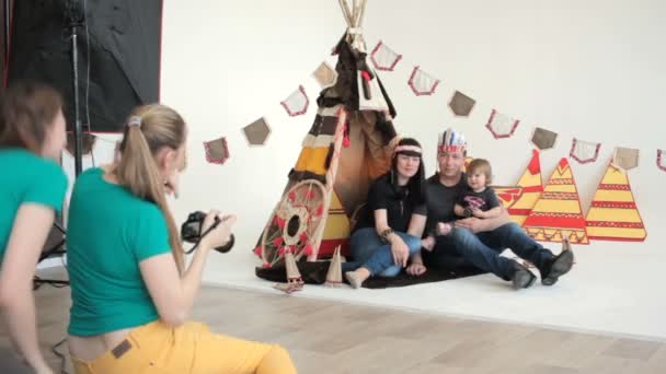 Famille avec bébé sur les mains pendant la séance photo — Video