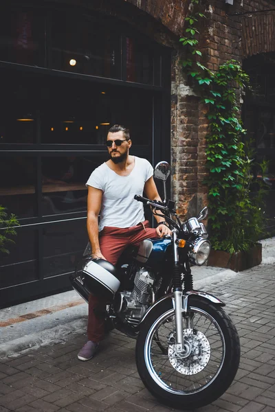 Young guy posing sitting on motorcycle — Stock Photo, Image