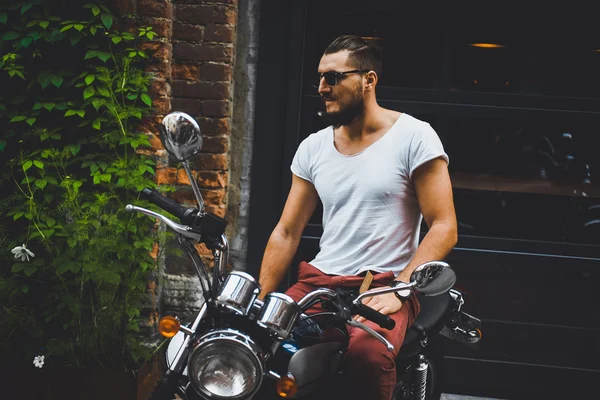 Young guy posing sitting on motorcycle — Stock Photo, Image