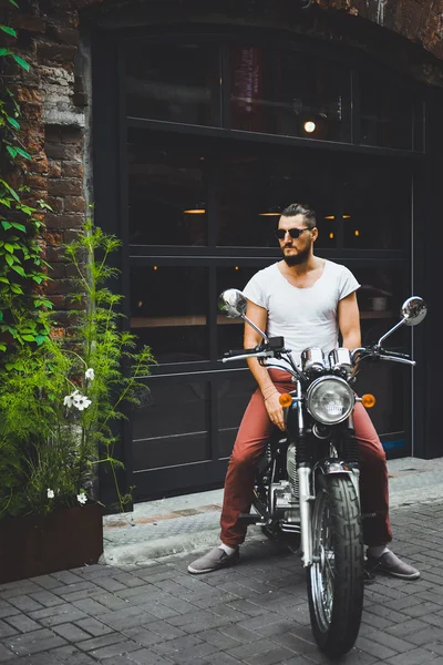 Young guy posing sitting on motorcycle — Stock Photo, Image