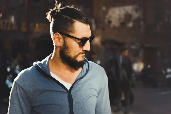 Young guy with a beard and mustache posing on the street — Stock Photo, Image