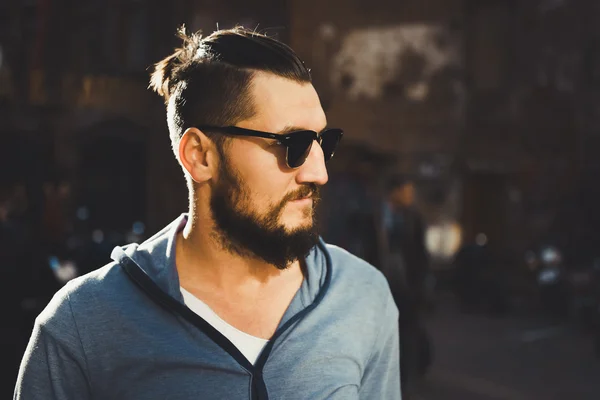 Young guy with a beard and mustache posing on the street — Stock Photo, Image
