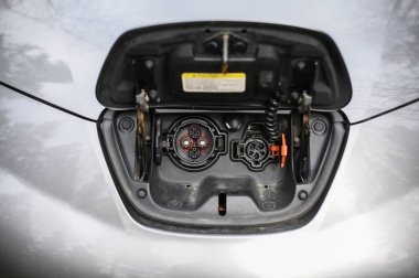 Tonsberg, Norveç - Nisan 06, 2021: Gri gri NISSAN LEAF, C segment elektrikli otomobil. Ormanda güneşli bir günde yeni bir araba.