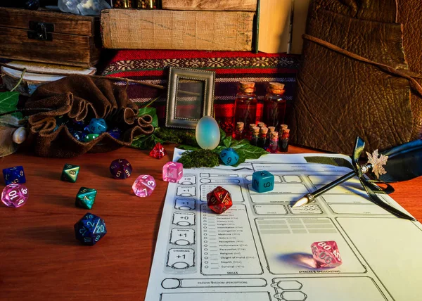 RPG tabletop game attributes, like polyhedral dice, dice bag and potion, on a wooden table in warm light