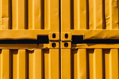 Abstract image of stacked yellow shipping containers in the sunlight