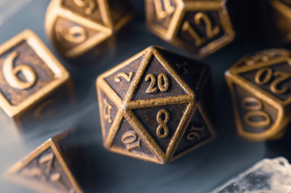 Close-up image of a 20-sided die surrounded by other polyhedral dice.