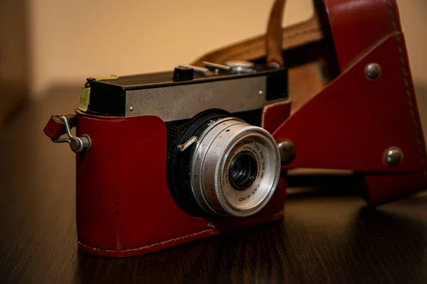 photographic equipment, retro camera on a brown background, vintage camera, leather case, brown antique