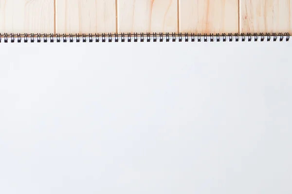 Empty blank brown front page cover of spiral bound notepad on the wooden background