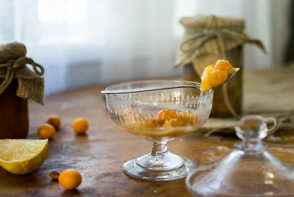 Yellow preserved cherry-plums in a transparent bowl — Stock Photo, Image