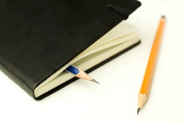 Diary and pencils on over white — Stock Photo, Image