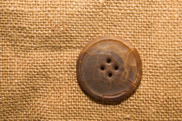 古い布の上の 1 つの大きなヴィンテージ ボタン — ストック写真