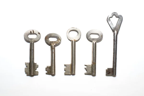 Five old keys to the safe on a white background — Stock Photo, Image