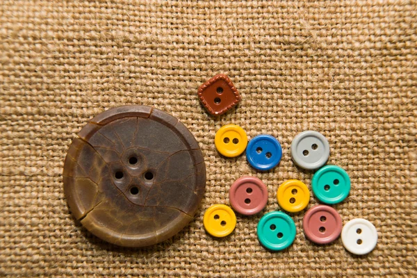 A lot of old buttons  on the old cloth — Stock Photo, Image