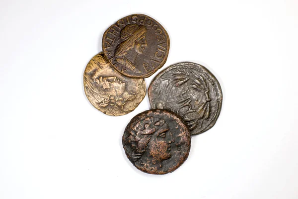 Four old coins with portraits of emperors on a white background — Stock Photo, Image