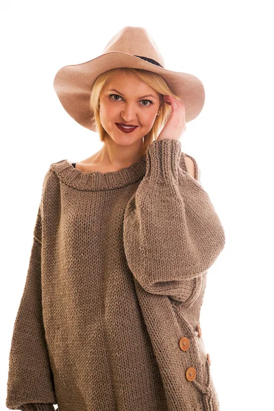 Girl in a sweater and cowboy hat smiling on a white background — Stock Photo, Image