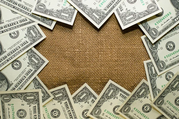 Banknotes dollars lined old cloth in a circle — Stock Photo, Image