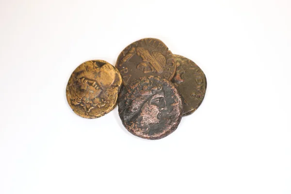 Four old coins with portraits of emperors on a white background — Stock Photo, Image