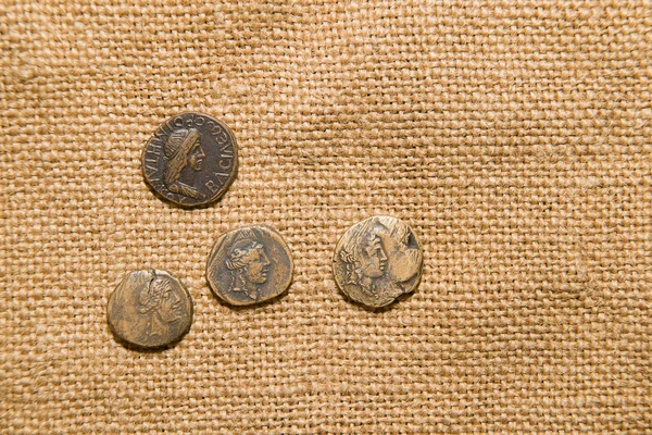 Antique coins with portraits of emperors are on sacking — Stock Photo, Image