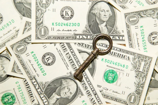 A lot of banknotes one US dollar and vintage key — Stock Photo, Image