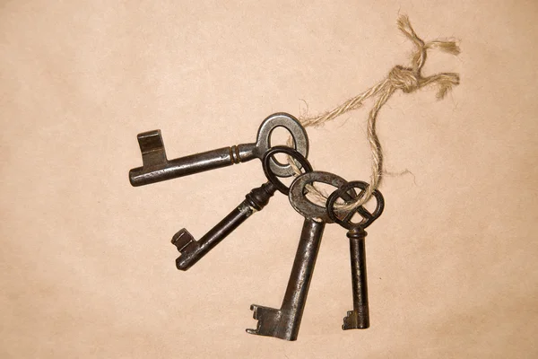 A lot vintage keys on a rope on paper craft — Stock Photo, Image