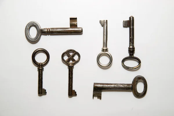 Six old  keys to the safe on a white background — Stock Photo, Image