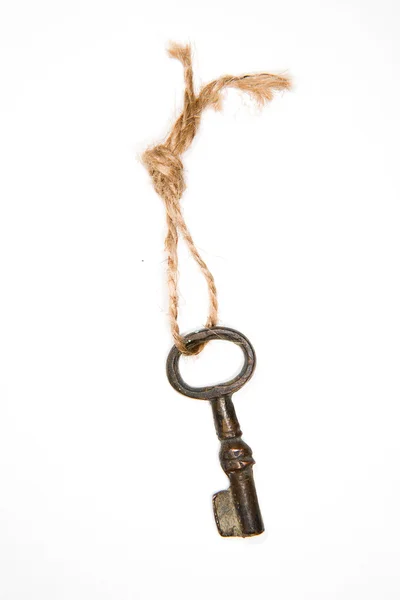 Old key on a rope on a white background — Stock Photo, Image