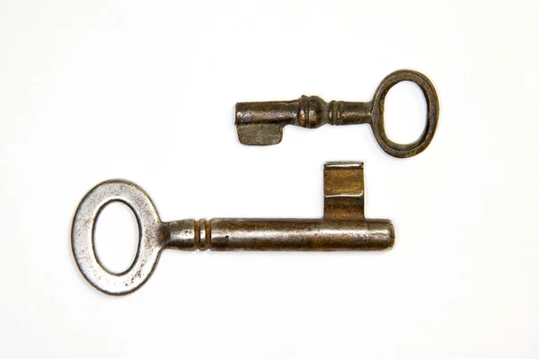 A lot vintage keys from the locks on a white background — Stock Photo, Image