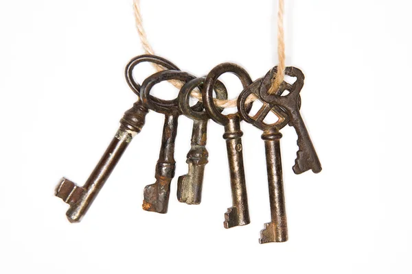 A lot vintage keys from the locks on a white background — Stock Photo, Image