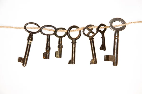 Beaucoup de clés vintage des serrures sur un fond blanc — Photo