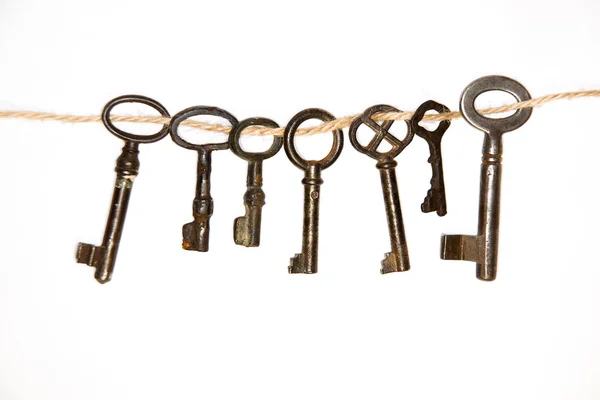 A lot vintage keys from the locks on a white background — Stock Photo, Image