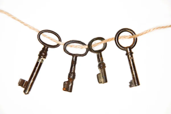 A lot vintage keys from the locks on a white background — Stock Photo, Image