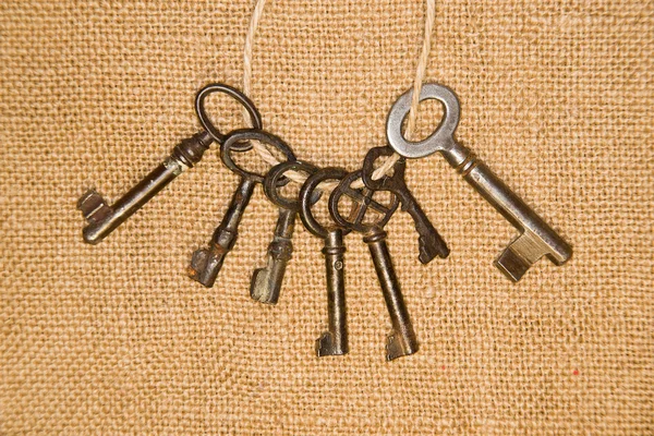 A lot vintage keys from the locks on old cloth — Stock Photo, Image