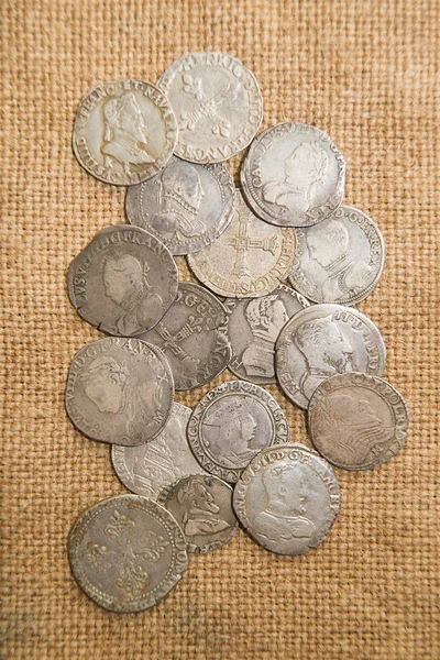 Vintage silver coins with portraits on the old cloth — Stock Photo, Image