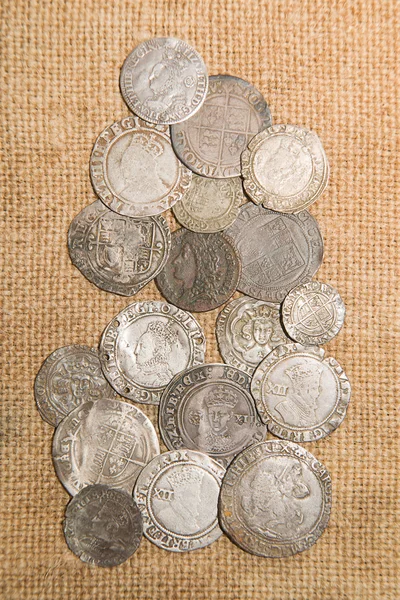 Vintage silver coins with portraits on the old cloth — Stock Photo, Image