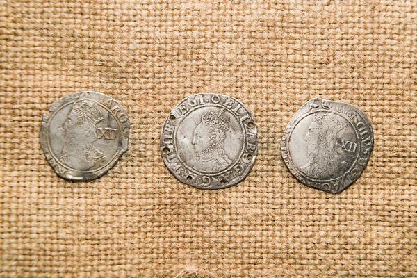 Vintage silver coins with portraits on the old cloth — Stock Photo, Image