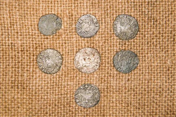 Vintage silver coins with portraits on the old cloth — Stock Photo, Image